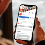 A young man going through QNET social media toolkit on his mobile