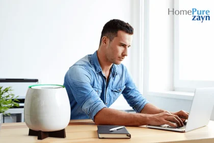 A young man working on his laptop next to Homepure Zayn