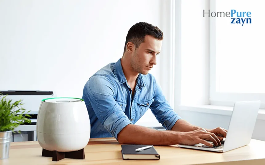 A young man working on his laptop next to Homepure Zayn