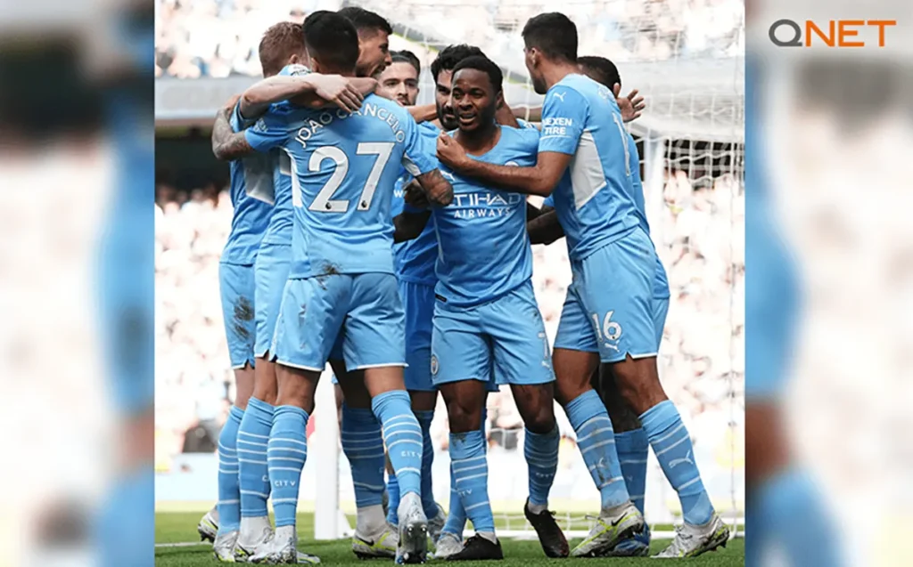 Manchester City players celebrate after scoring a goal