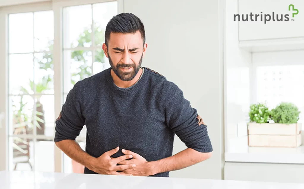 A young Indian man expressing distress due to liver pain at his home