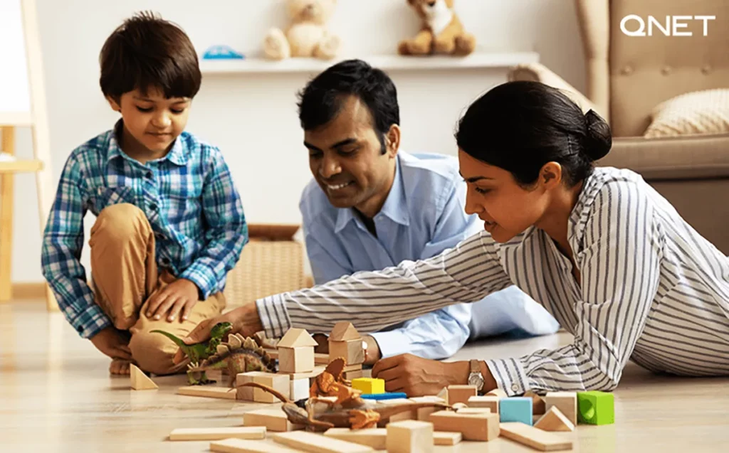 Financially independent parents playing with their son in their home