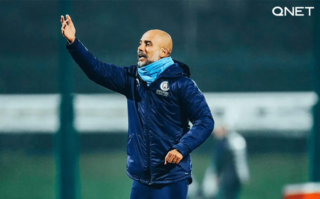 Manchester City’s manager Pep Guardiola giving instructions to players during a training session